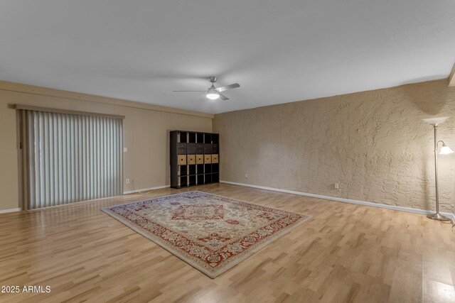 unfurnished living room featuring hardwood / wood-style flooring and ceiling fan