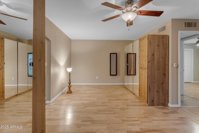 spare room with ceiling fan and light hardwood / wood-style flooring