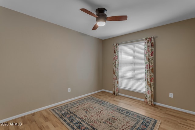 spare room featuring light hardwood / wood-style floors and ceiling fan