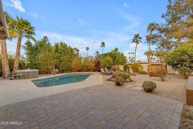 view of pool featuring a patio area and a hot tub