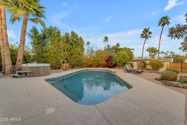 view of pool with a patio and a hot tub