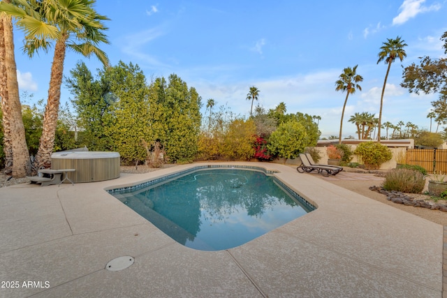 view of swimming pool featuring a hot tub and a patio