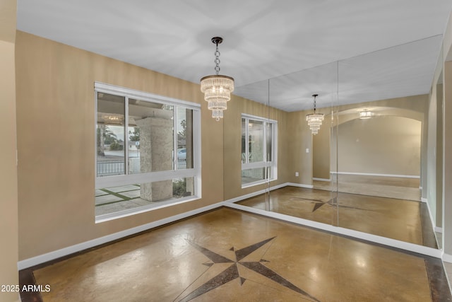 unfurnished dining area with an inviting chandelier