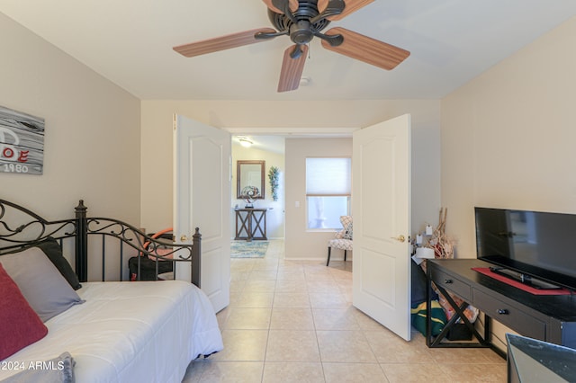 bedroom with ceiling fan and light tile patterned floors