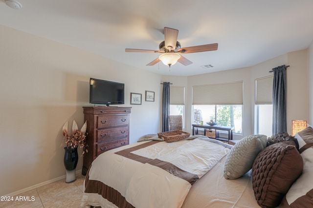 tiled bedroom with ceiling fan