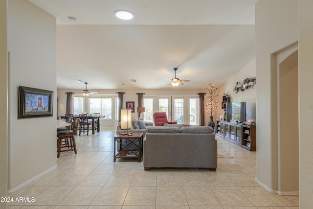 tiled living room featuring vaulted ceiling and ceiling fan