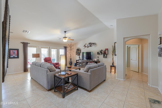 living room with ceiling fan, light tile patterned floors, and lofted ceiling