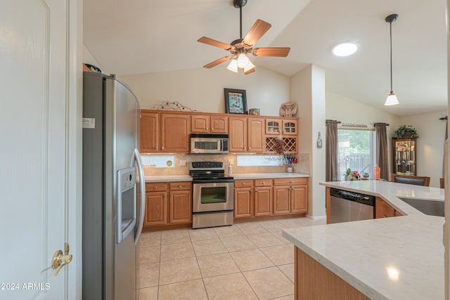 kitchen featuring pendant lighting, light tile patterned floors, appliances with stainless steel finishes, and vaulted ceiling