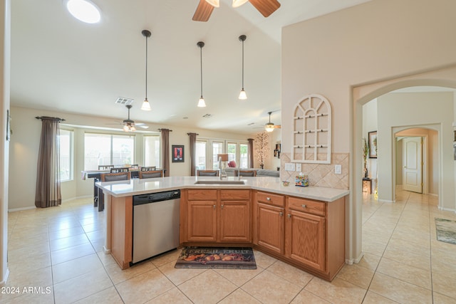 kitchen featuring dishwasher, kitchen peninsula, a wealth of natural light, and tasteful backsplash