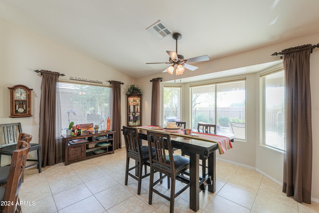 tiled dining area with ceiling fan and vaulted ceiling