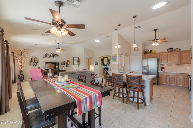 dining space featuring light tile patterned floors, vaulted ceiling, ceiling fan, and sink