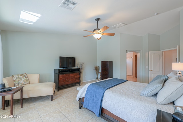 bedroom with ceiling fan, light tile patterned floors, and high vaulted ceiling