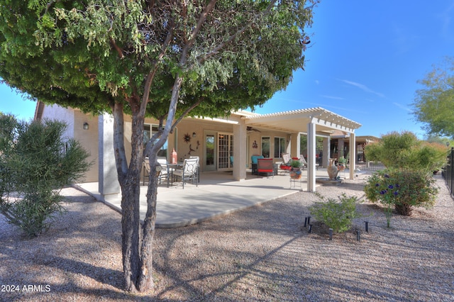 rear view of property with an outdoor living space, a pergola, ceiling fan, and a patio area