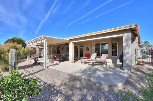 back of property with a pergola, ceiling fan, and a patio area