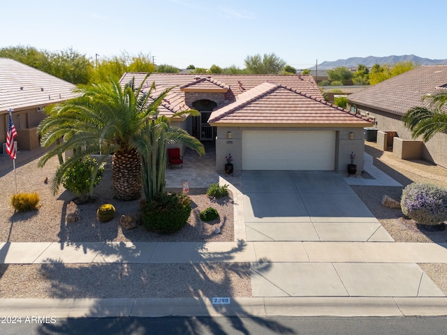 view of front facade featuring a mountain view and a garage