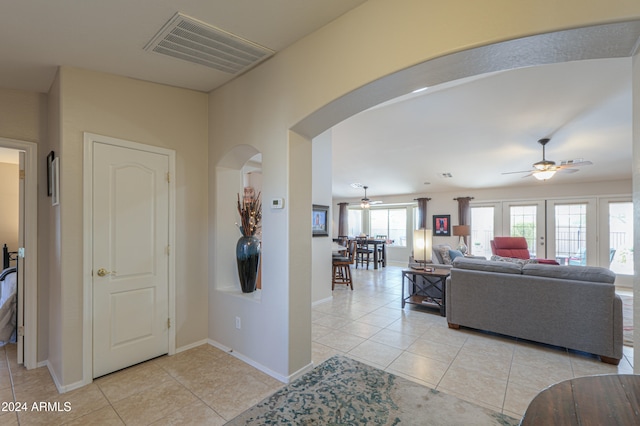 interior space featuring light tile patterned flooring and french doors