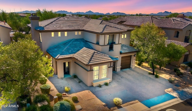 view of front of house featuring a garage and a mountain view