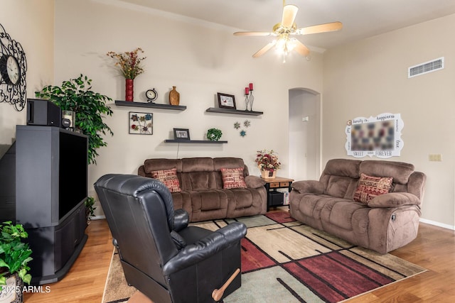 living room with hardwood / wood-style floors and ceiling fan