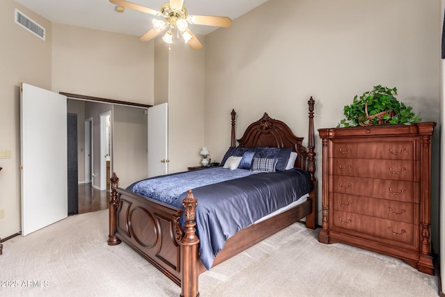 bedroom with ceiling fan and light carpet