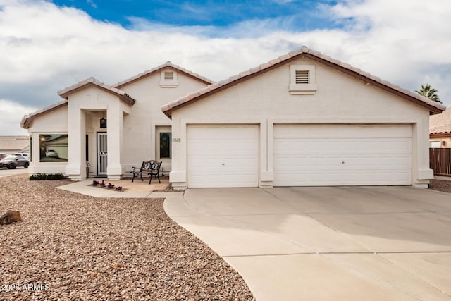 view of front of property featuring a patio and a garage