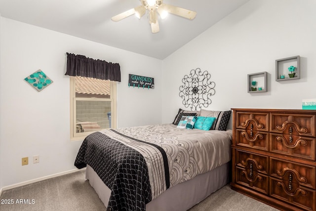 carpeted bedroom featuring ceiling fan, ensuite bathroom, and vaulted ceiling