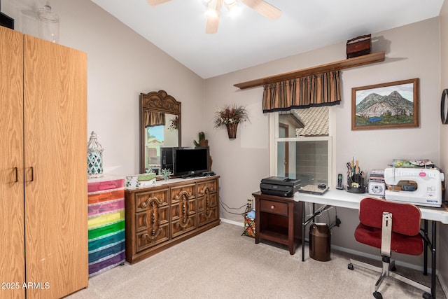 carpeted office space featuring ceiling fan and lofted ceiling