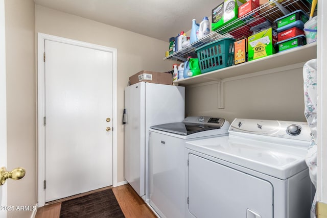 washroom featuring washer and dryer and hardwood / wood-style flooring