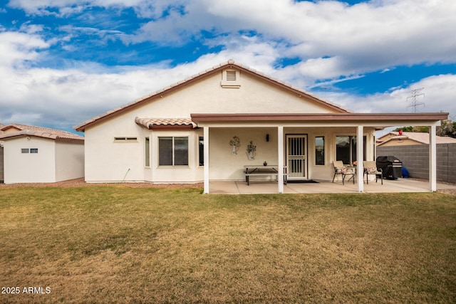 back of house featuring a yard and a patio