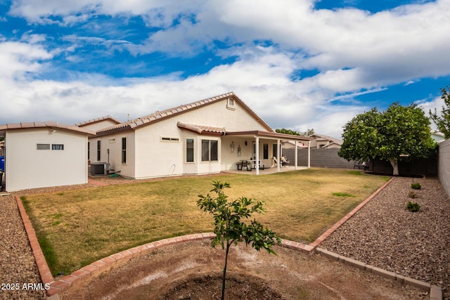 back of house with a patio, cooling unit, and a lawn