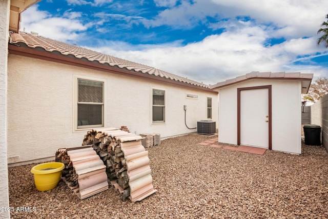 back of property with cooling unit and a shed