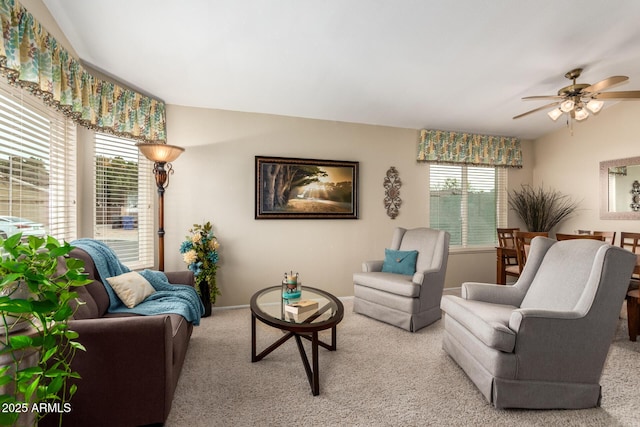 carpeted living room with ceiling fan