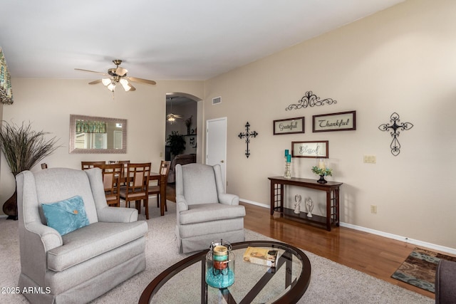 living room featuring ceiling fan and hardwood / wood-style flooring