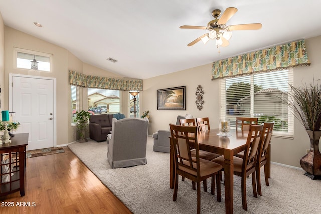 dining area featuring hardwood / wood-style flooring, ceiling fan, and lofted ceiling