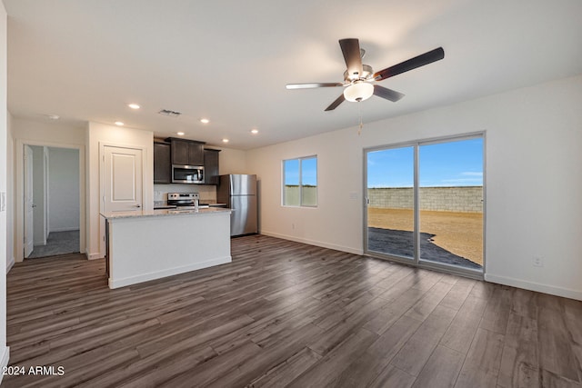 unfurnished living room featuring ceiling fan and dark hardwood / wood-style floors