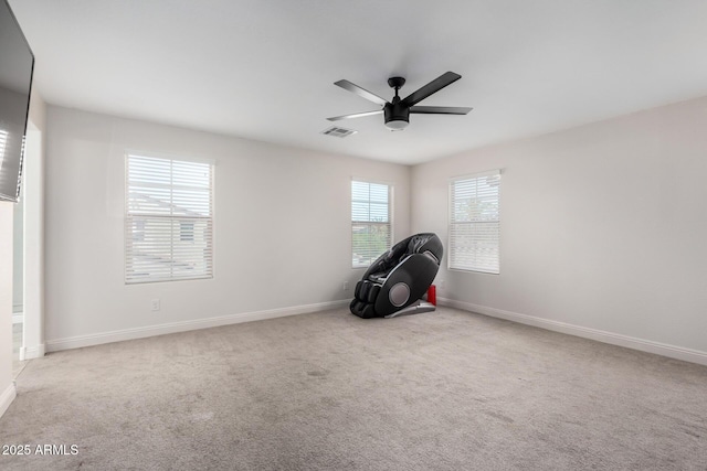 empty room with a ceiling fan, baseboards, and carpet flooring