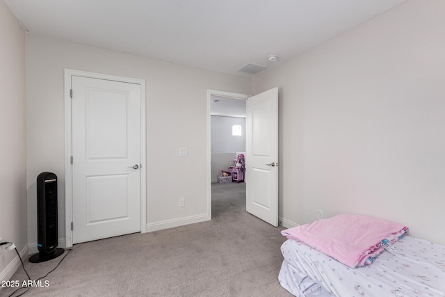 bedroom featuring light colored carpet and baseboards
