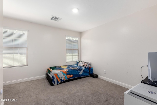 carpeted bedroom featuring baseboards