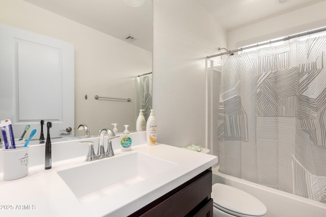 bathroom with shower / bath combo with shower curtain, toilet, and vanity