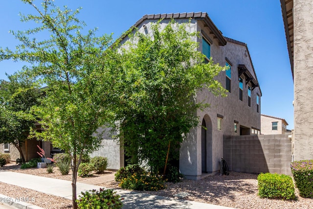 view of front of home featuring fence and stucco siding