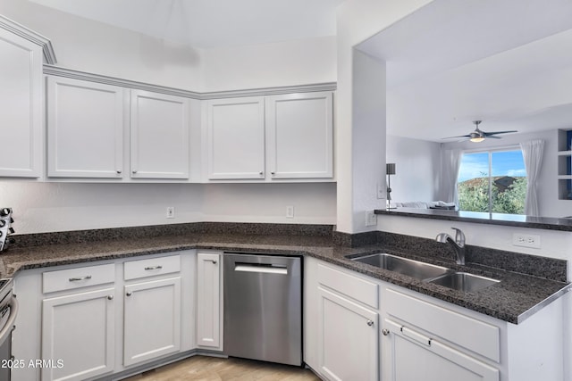 kitchen featuring ceiling fan, dark stone countertops, stainless steel dishwasher, sink, and white cabinets