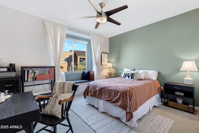 bedroom with ceiling fan and light carpet