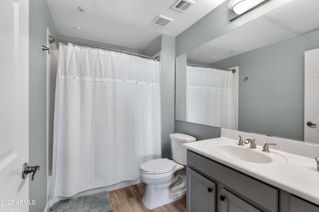 bathroom with toilet, vanity, wood-type flooring, and a shower with shower curtain