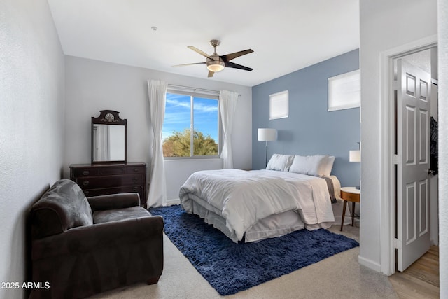 bedroom with ceiling fan and light hardwood / wood-style floors