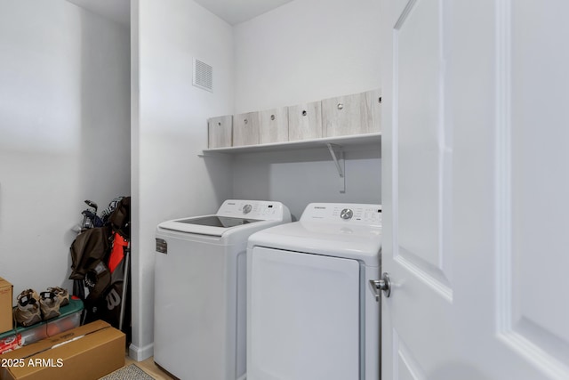 washroom with hardwood / wood-style flooring and independent washer and dryer