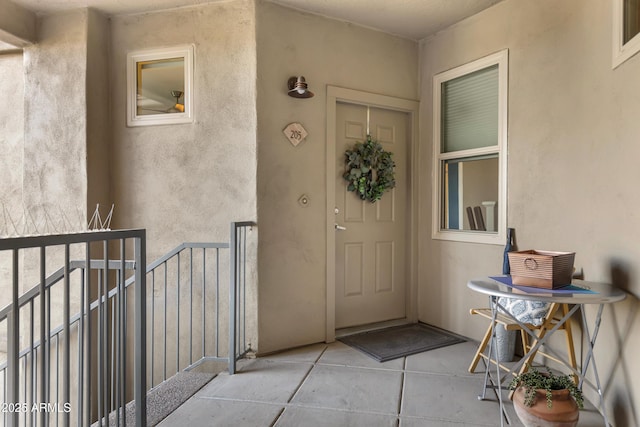 view of exterior entry featuring a balcony