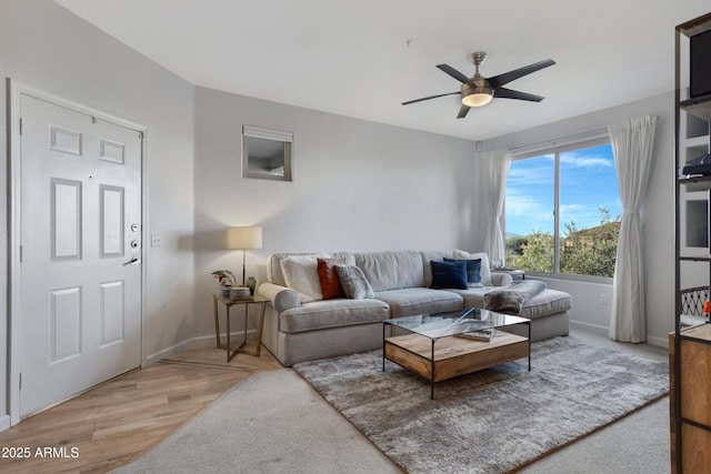 living room featuring ceiling fan and light wood-type flooring