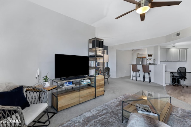 carpeted living room featuring ceiling fan