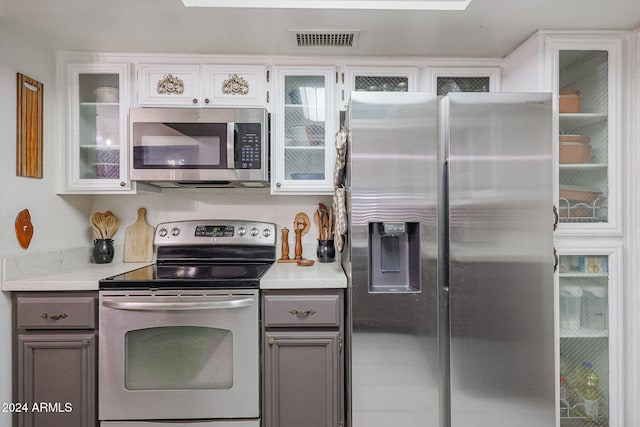 kitchen featuring white cabinets and appliances with stainless steel finishes