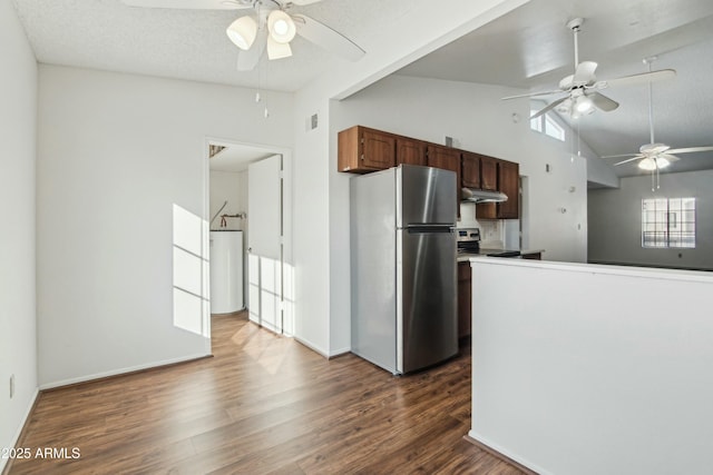 kitchen with lofted ceiling, ceiling fan, appliances with stainless steel finishes, a textured ceiling, and dark hardwood / wood-style flooring