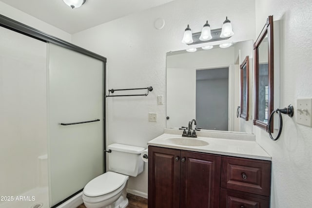 bathroom with vanity, walk in shower, and toilet